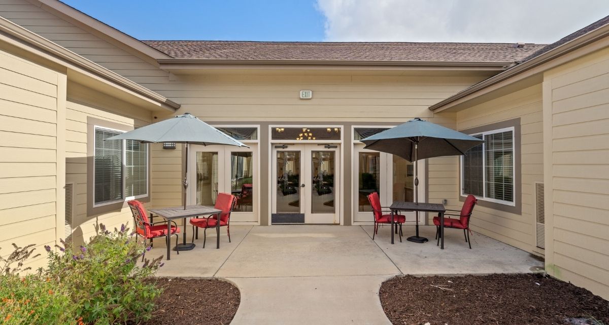 courtyard entrance with outdoor tables and chairs with umbrellas